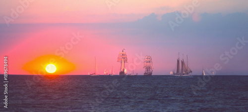 Sailing ship race in sun rays. Tall Ships. (travel, freedom, adventure concept).