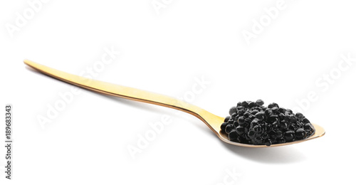 Black caviar in spoon on white background