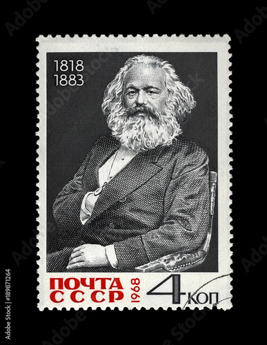 Karl Marx (1818-1883), famous politician leader, Capital book author, circa 1968. Vintage postal stamp printed in the USSR isolated on black background.