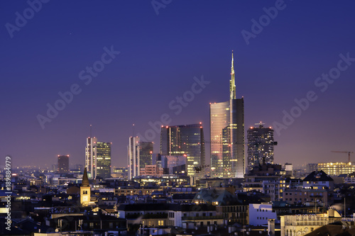 Milan skyline by night, new skyscrapers with colored lights. Italian landscape panorama.