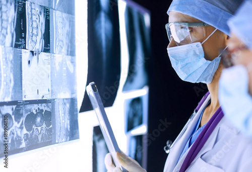 Two female women medical doctors looking at x-rays in a hospital.