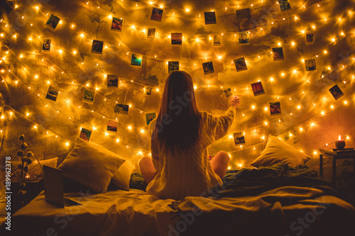 Young woman weekend at home decorated bedroom memories