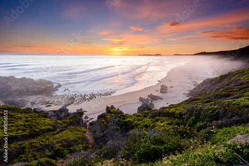 Long exposure of a colourful sunset over Brenton-on-sea main beach in South Africa