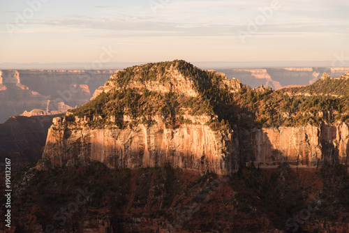 The sun setting oin the walls of the Grand Canyon's North Rim in Arizona. 