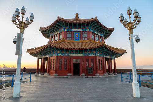 Zhanqiao pier at sunrise, Qingdao, Shandong, China. The name "Huilan Pavilion" is engraved above the entrance door.