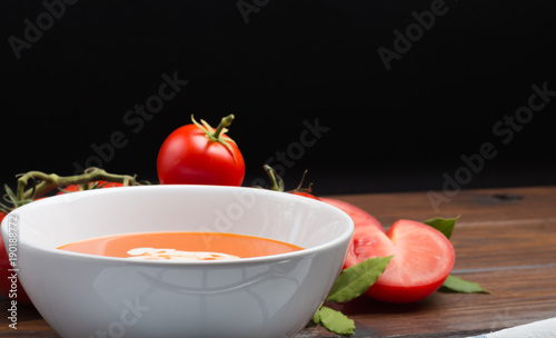 tomato soup on a wooden table front view