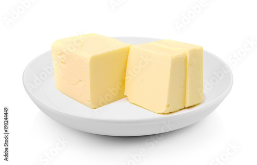 Stick of butter in a plate on white background