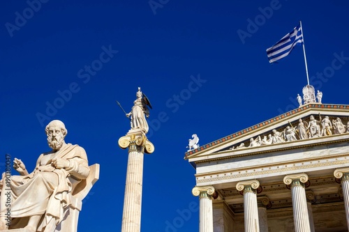 The statues of the ancient Greek philosopher Plato and the ancient Greek Goddess Athena in front of the Academy of Athens in Athens, Greece.