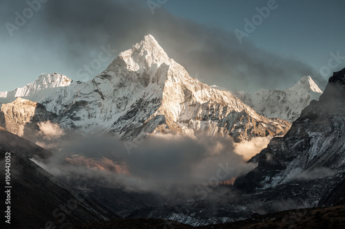 Ama Dablam mountain. Sun illuminates slopes. Himalayan mountains, Nepal.