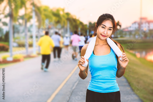 A women is exercising and relaxing at the park.