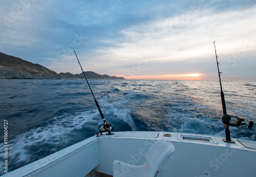 Sunrise view of fishing rod on charter fishing boat on the Pacific side of Cabo San Lucas in Baja MEX BCS