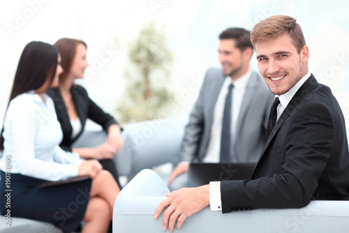successful business man at the office on the background of business team