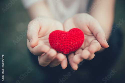 Sharing Love and Heart red color on women hand in valentine's day vintage color tone