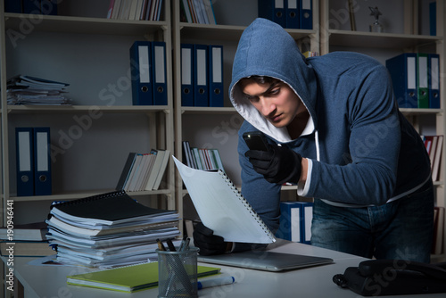 Young man in industrial espionage concept