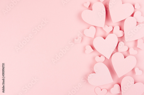 Paper pink hearts fly on soft pink color background, border, copy space. Valentine day concept for design.