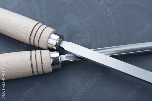 Professional chisels on a dark wooden background