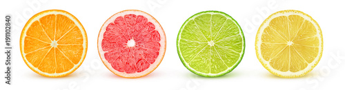 Isolated citrus slices. Fresh fruits cut in half (orange, pink grapefruit, lime, lemon) in a row isolated on white background with clipping path