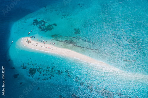 Aerial view of beautiful sand tropical island with white sand beach and tourists, Zanzibar