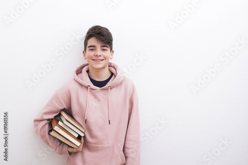 teenage student with books on the white wall