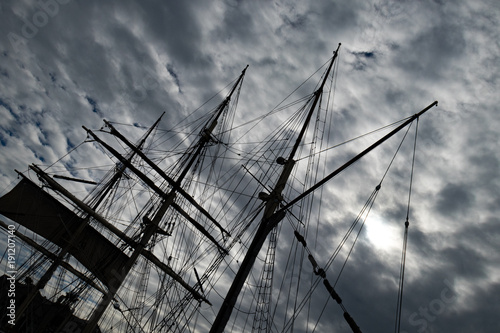 Sailboat Mast and ropes with cloudy blue sky in the background