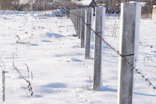 barbed wire fence in winter