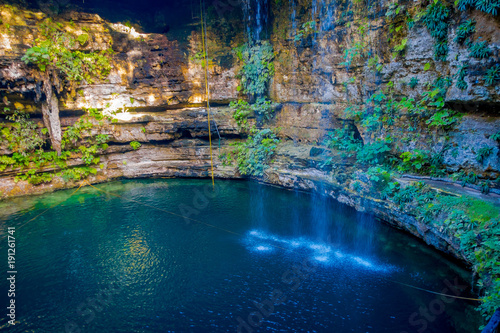 Ik-Kil Cenote near Chichen Itza, Mexico. Lovely cenote with transparent turquoise waters and hanging roots