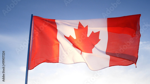 Canada flag on clear blue sky