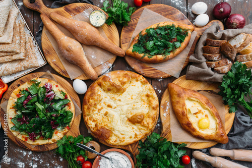 Traditional Georgian adjara khachapuri and Kolkh khachapuri on the table. Homemade baking. Top view. Flat lay