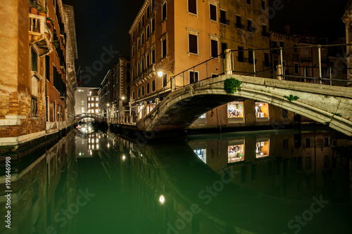 small channel and bridges in lagoon city venice at night. long exposure Venezia Italy