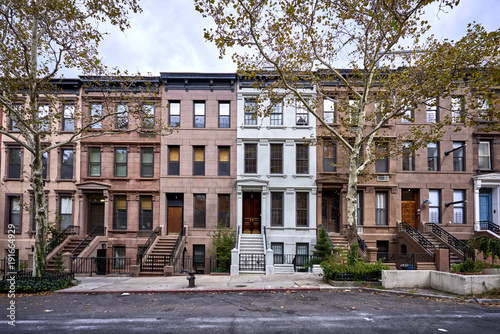 a view of a row of historic brownstone buildings in an iconic neighborhood of Manhattan, New York City