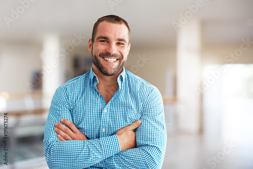 Smiling man standing in business center