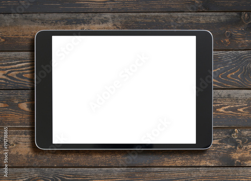 tablet pc with blank screen top view on old wood table