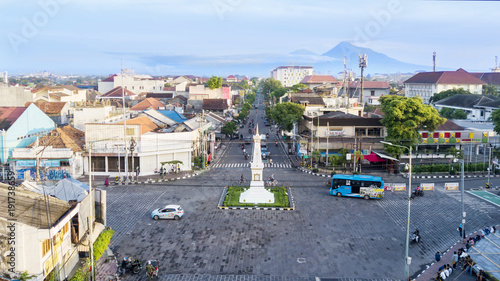 Tugu Yogyakarta with mount under blue sky