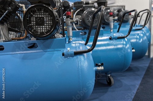 Many compressors lined up in garage