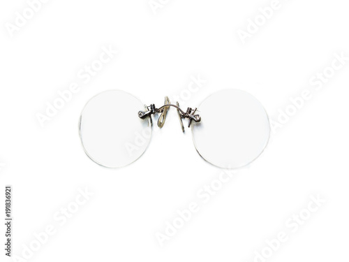 Vintage round pince-nez eyeglasses isolated on white background. Antique reading glasses, rimless eyeglasses