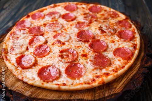 Delicious fresh baked pizza with pepperoni and cheese, close up. Italian traditional cuisine, fast food.