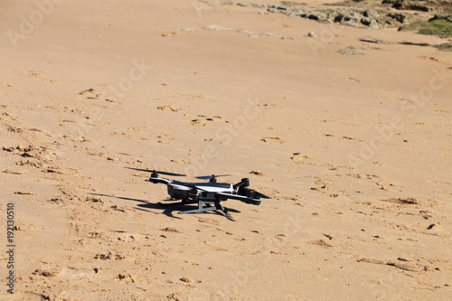 Drone landed on the beach sand
