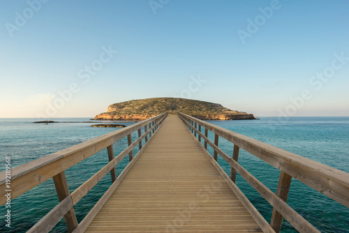 Wooden footbridge by the water to an island