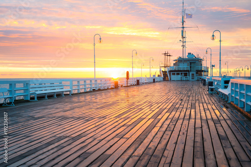 The first rays of the sun warms the wet boards of the pier in Sopot. Poland.