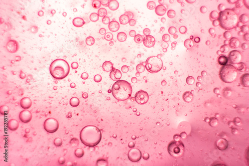Pink oil bubbles on water surface