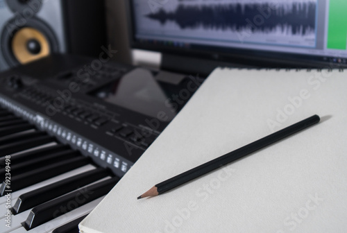 Piano keyboard, pen and sheet. Concept of composing song.