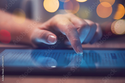 Woman reading online news on digital tablet