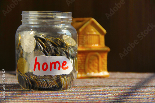 Coins in money jar with home label