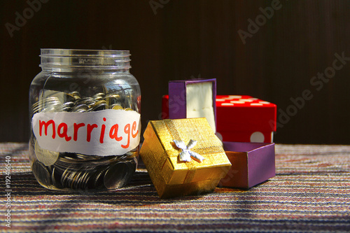 Coins in money jar with marriage label,