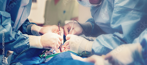 Medical team of surgeons in hospital doing minimal invasive surgical interventions. Surgery operating room with electrocautery equipment for cardiovascular emergency surgery center.