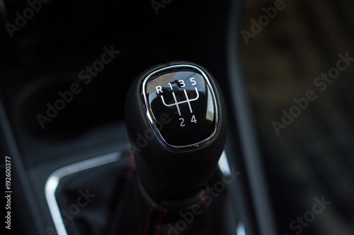 manual transmission gear shift, on dark backgroun.