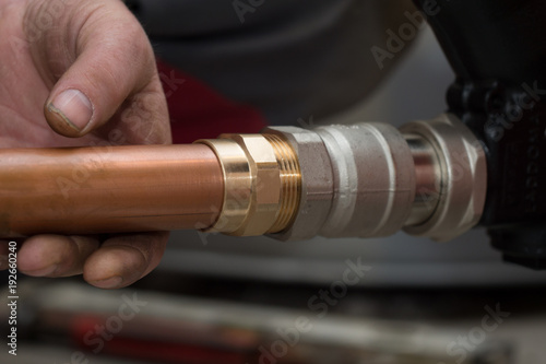 workers cut a copper pipe