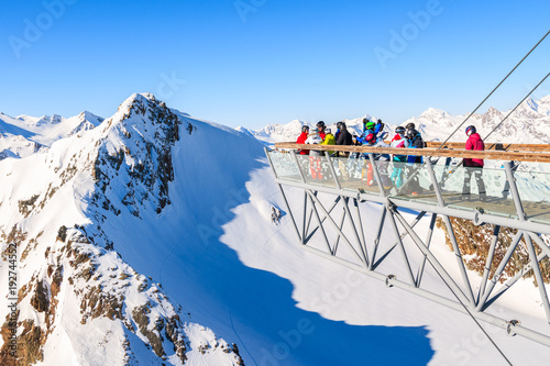 SOLDEN SKI RESORT, AUSTRIA - JAN 29, 2018: Skiers looking at mountains from platform in Solden ski area on beautiful sunny winter day, Tirol, Austria.