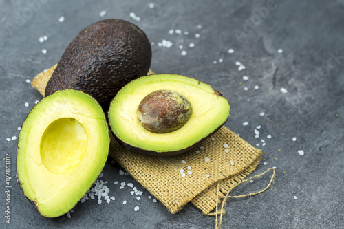 Fresh avocado on black old wooden table.