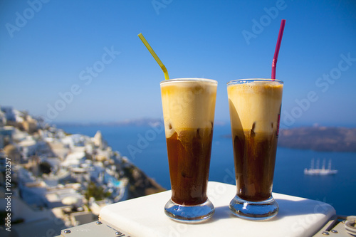 Greece Santorini island in Cyclades, coffee espresso freddo with wide sea of caldera in greek caffe